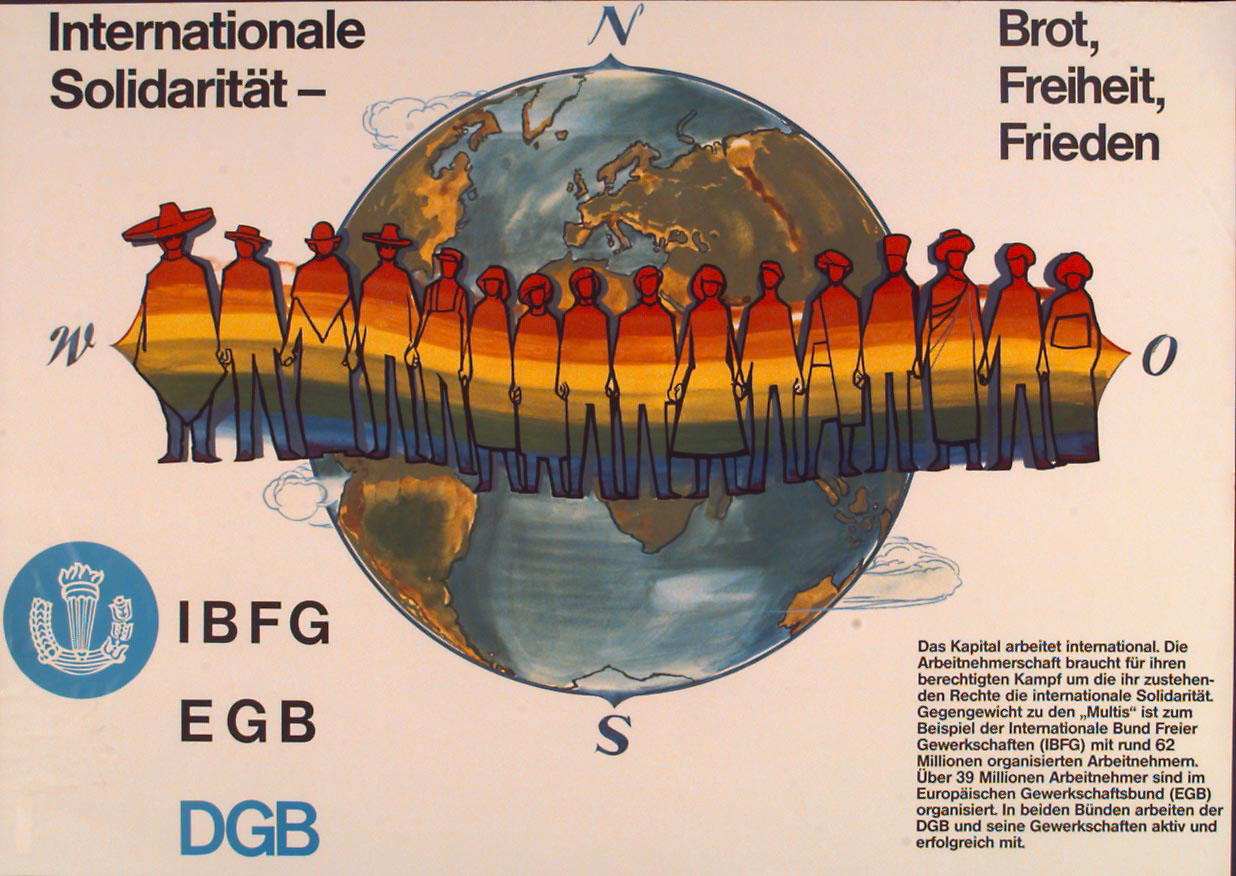 Plakat, auf dem eine Menschenkette in Regenbogenfarben, die sich um eine Weltkugel schlingt, Beschriftung des Plakats: Internationale Solidarität. Brot, Freiheit, Frieden