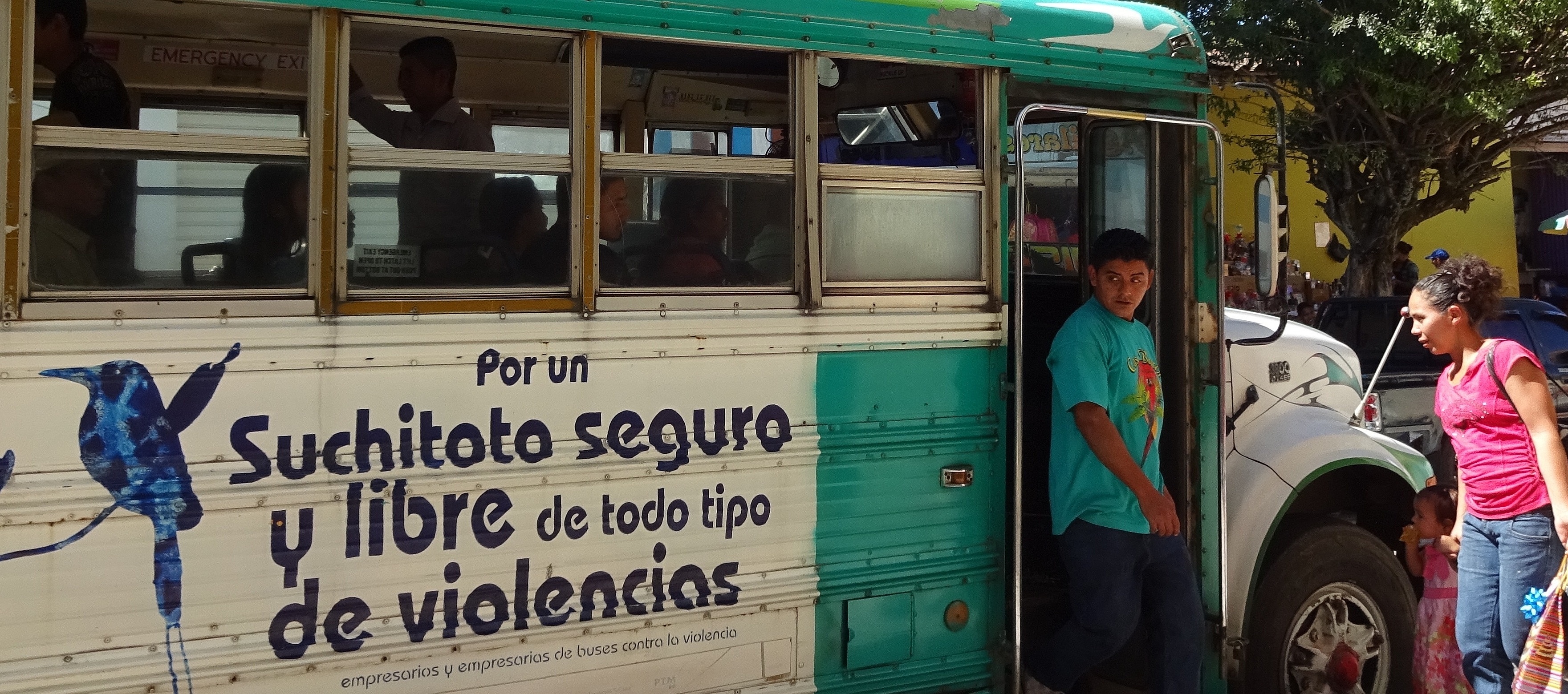 Menschen beim Ein- und Aussteigen in den/aus dem Bus in El Salvador