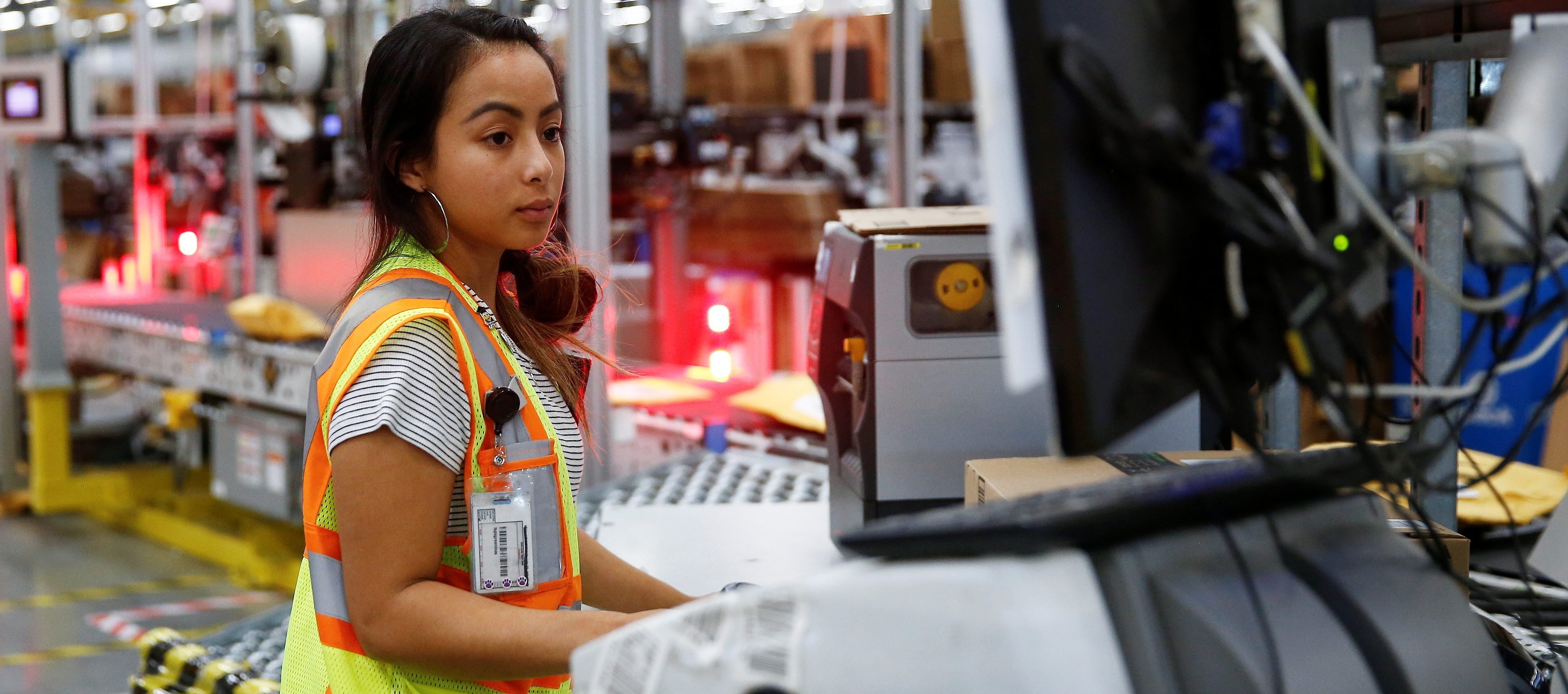 Amazon employee works on processing packages in Kent, Washington DC, REUTERS, 