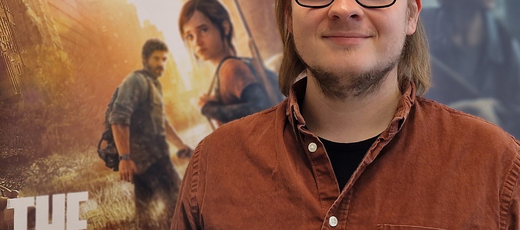 Christoph Lahusen in seinem Büro vor den Plakaten zu dem Videospiel The Last of Us Part 1 und The Last of Us Part 2