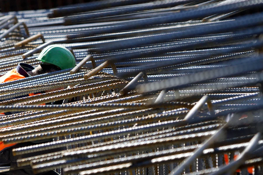 A worker leans down to a colleague in the midst of steel girders for the new building of the European Central Bank (ECB) in Frankfurt am Main. 