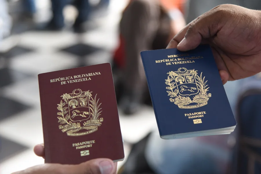 Venezuelan migrants show their passports.