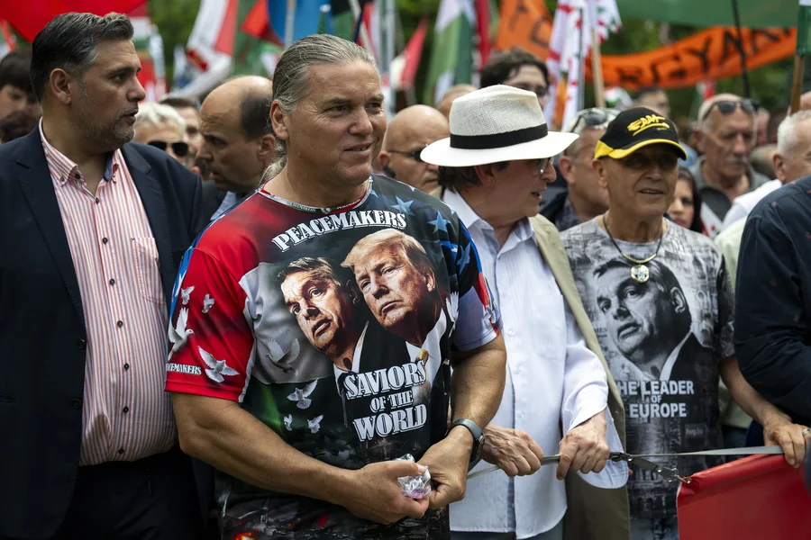 A man wearing a T-shirt showing Viktor Orban and Donald Trump, attends a "peace march" in support of Prime Minister Viktor Orbán and his party in Budapest.
