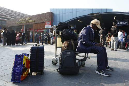 A Nepali migrant worker waits at Tribhuvan International Airport in Kathmandu, Nepal.