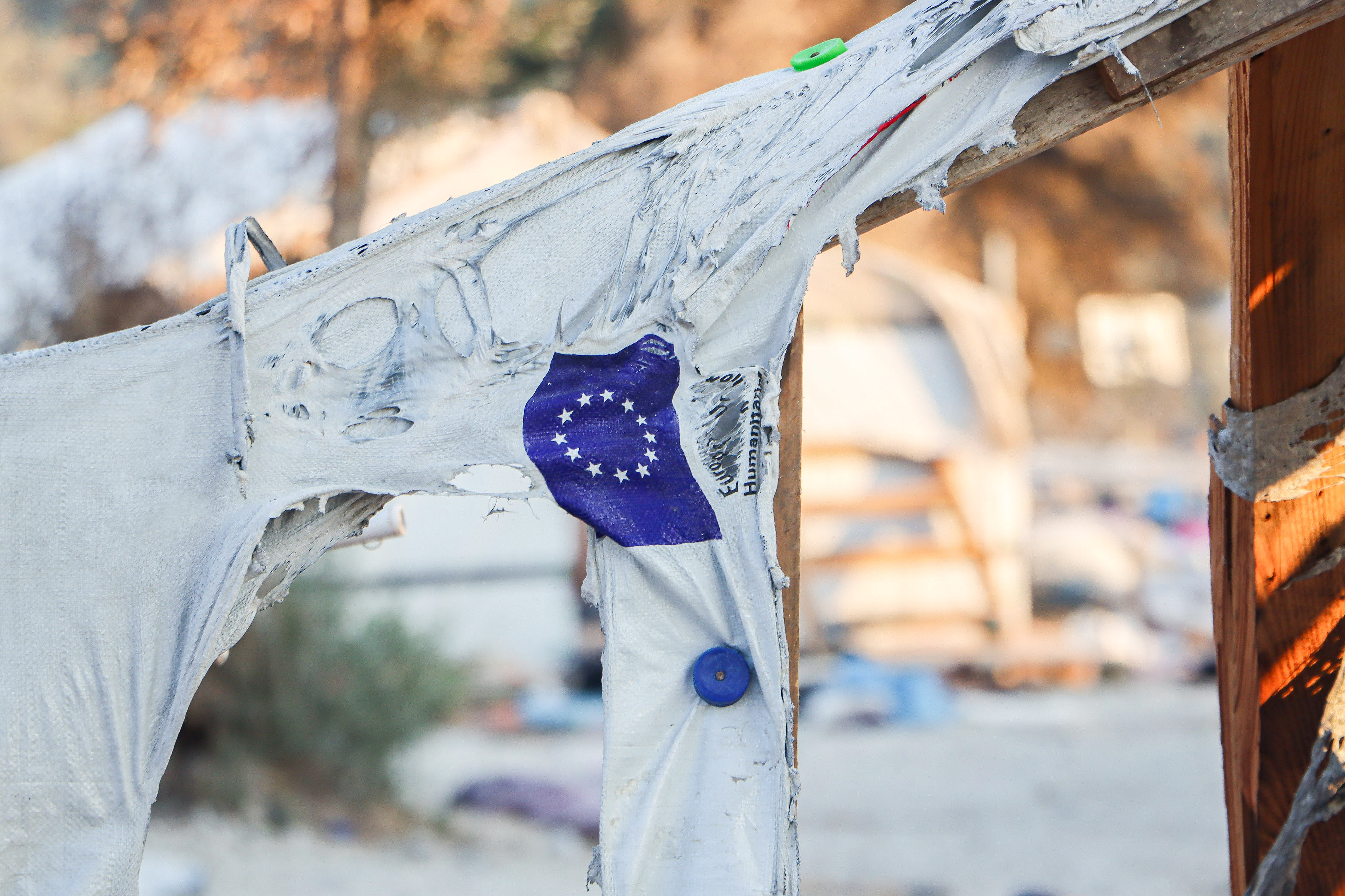 The EU flag on a molten tent in Moria refugee camp after the fire.
