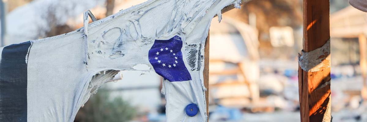 The EU flag on a molten tent in Moria refugee camp after the fire.