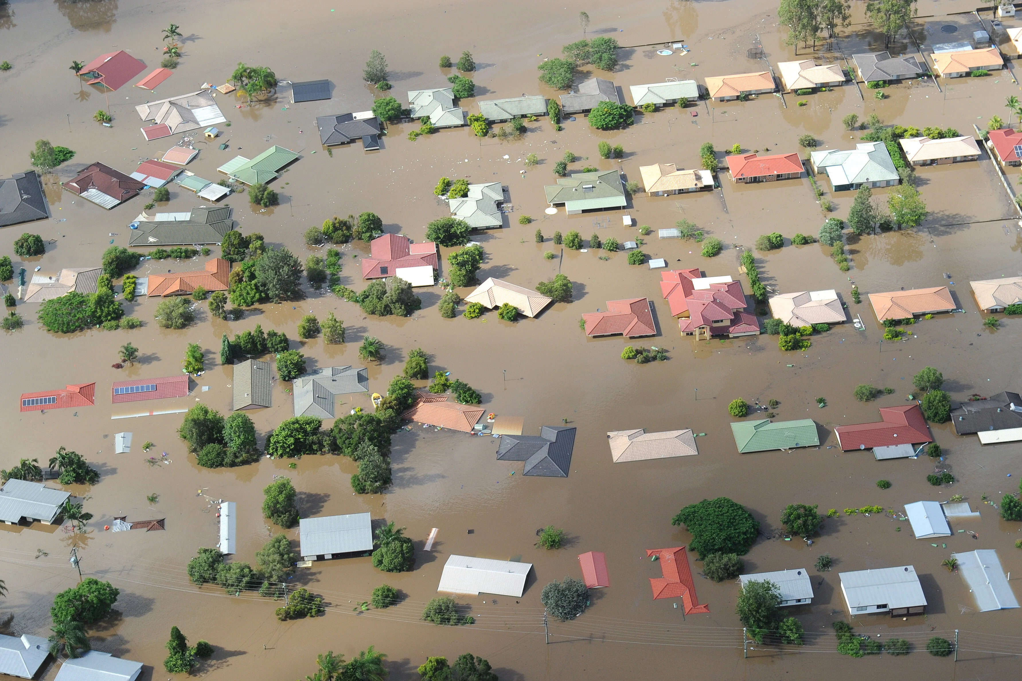 Sicht von oben auf die Häuser in der Stadt Ipswich westlich von Brisbane. Sie werden von den Fluten überschwemmt.